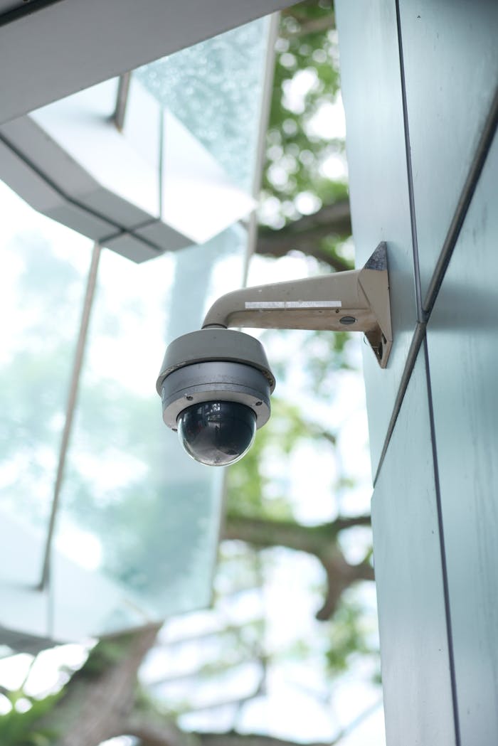 Mastering the First Impression: Your intriguing post title goes here A high-tech surveillance camera installed on a modern architecture outdoor wall.